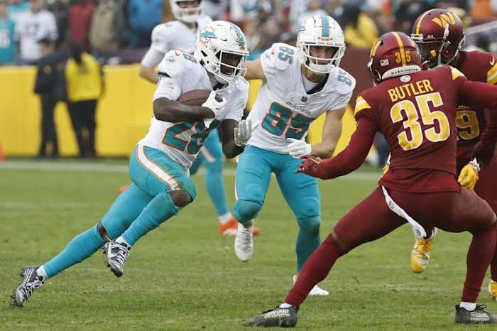 Dec 3, 2023; Landover, Maryland, USA; Miami Dolphins running back De'Von Achane (28) carries the ball as Washington Commanders safety Percy Butler (35) defends during the fourth quarter at FedExField.